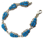 Scarab bracelet in Silver with inlaid stones.
